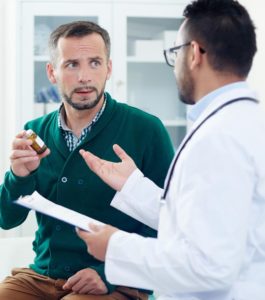 Man discussing MAT treatment with doctor