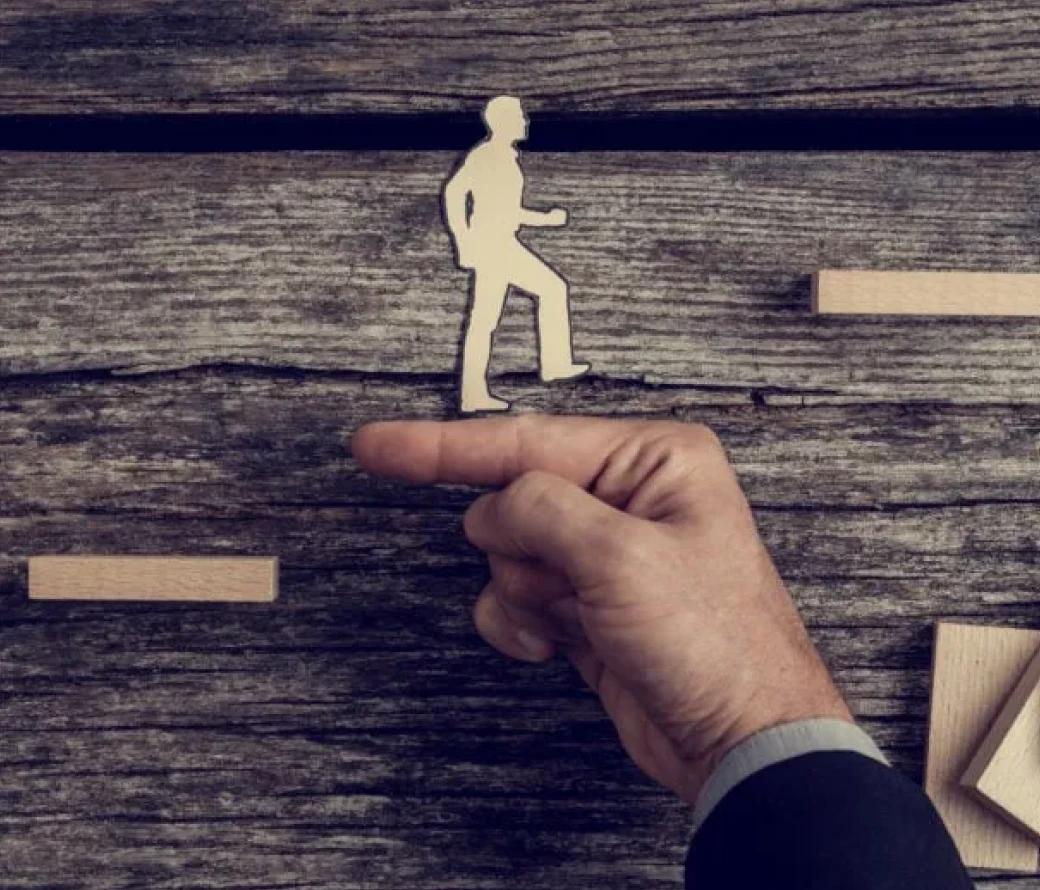 Wood cutout of a man walking up steps