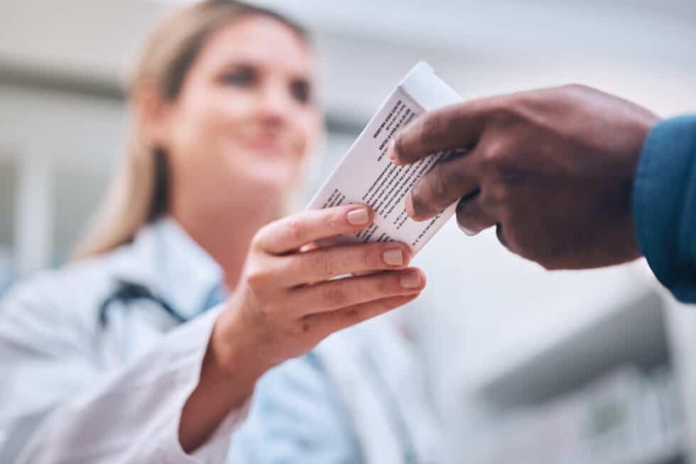 A Pharmacist handing medication to a patient