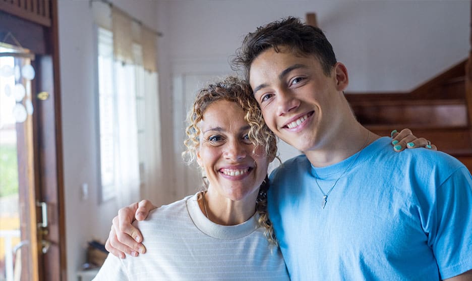 Woman and son smiling at the camera