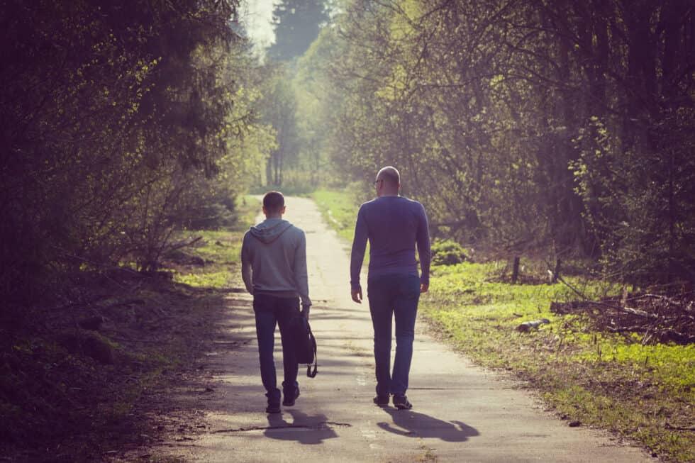 To men walking down a bike path together