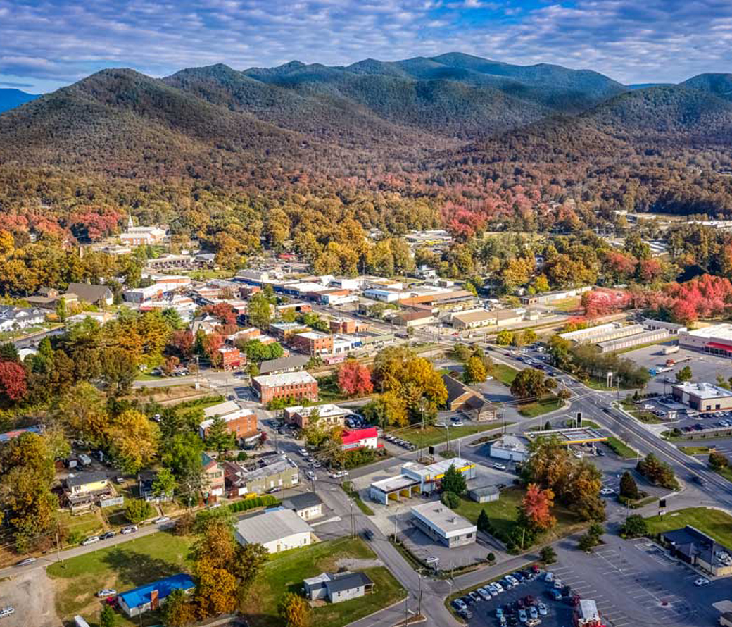 Aerial view of a North Carolina town at the foot of mountains